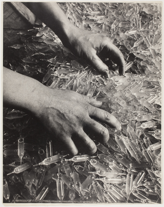 [Hands in a pile of phials, France]