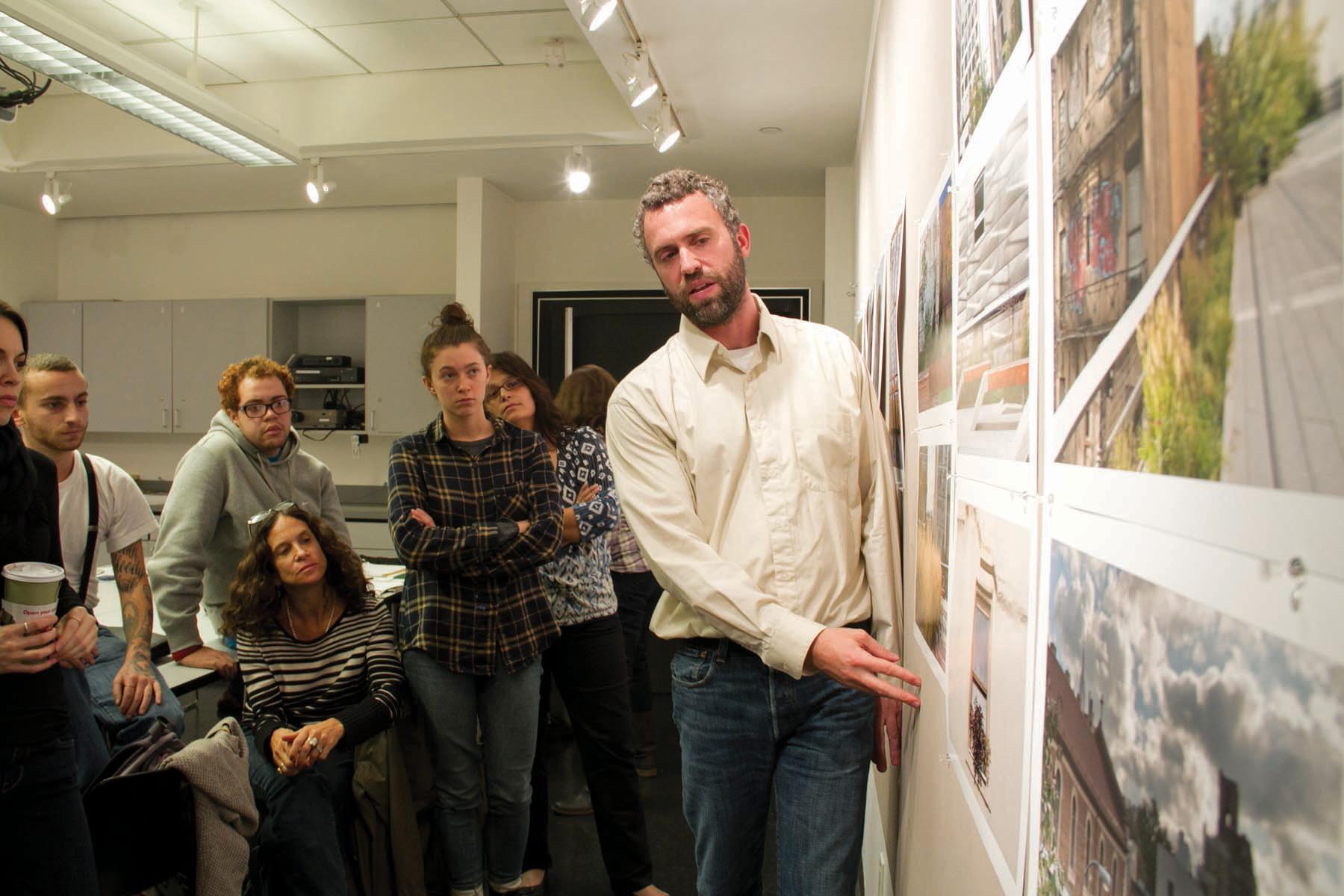 A man presenting in front of a small group.