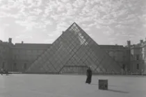 A man in front of a triangle building.