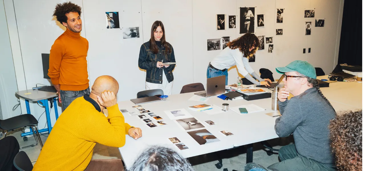 Program chair looking at images with students in classroom